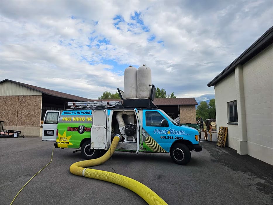 Fresh Ducts van on site with its hose run out to a property
