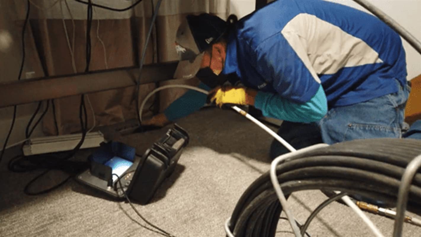 Technician setting up cleaning equipment inside a property