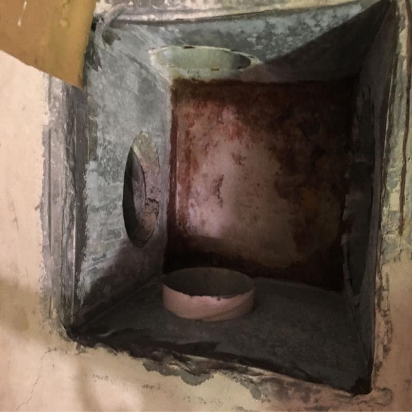 Interior of a corroded duct plenum before treatment