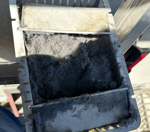A dryer vent transition packed with matted lint