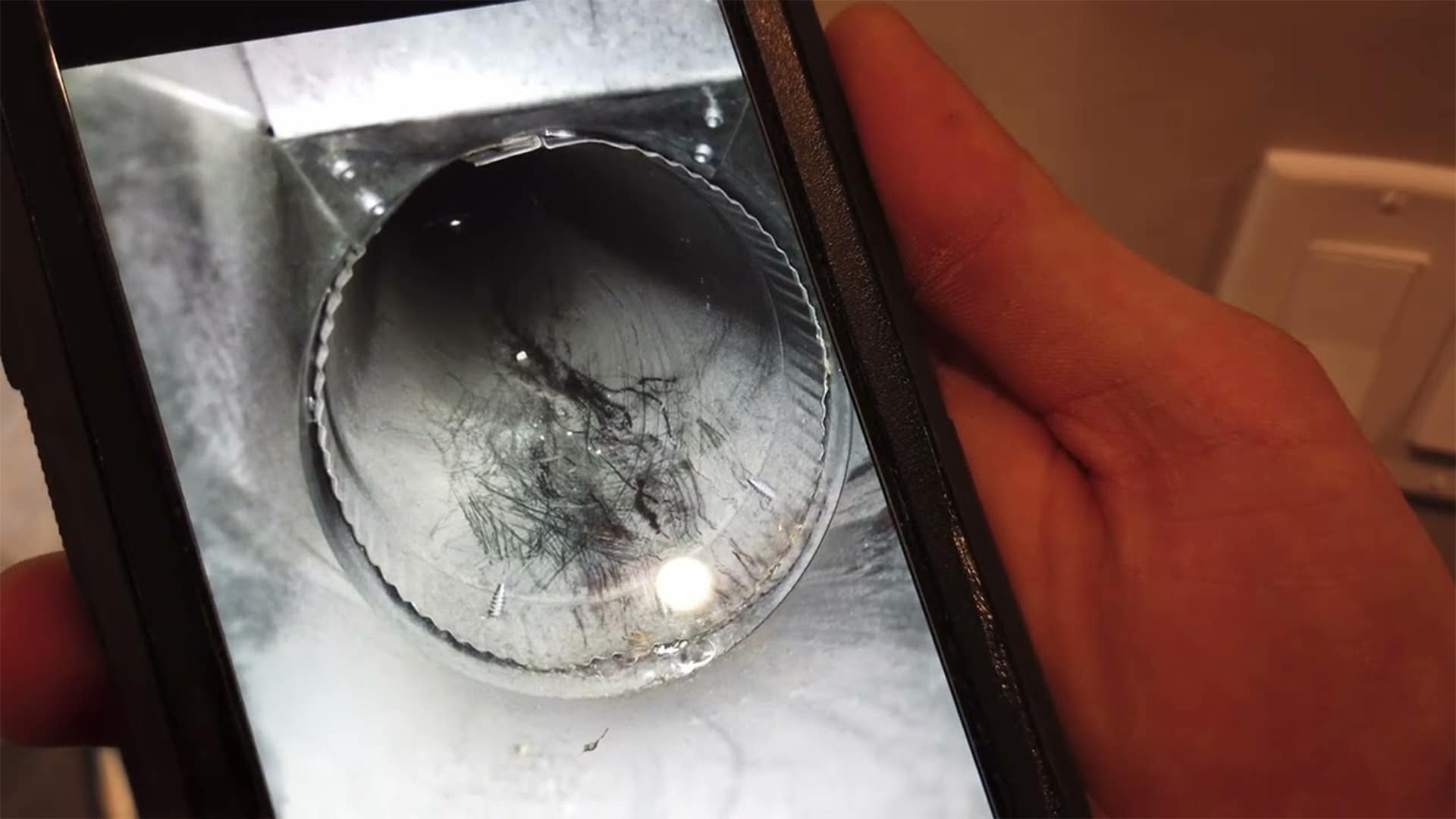 Close-up inspection image showing buildup inside residential ductwork